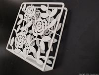 Front view of white floral cutout napkin holder