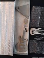 Miniature guitar in original presentation box with stand and business card