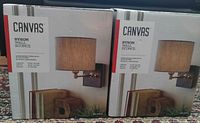 Two boxed CANVAS Byron wall sconces
