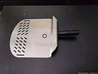 Full view of stainless steel perforated pizza peel