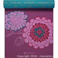 Magenta floral side of mat unrolled showing Gaiam logo