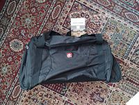 Top view of black Swiss Gear duffel bag with tag attached