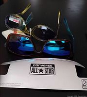 Both Converse and Foster Grant sunglasses with tags visible