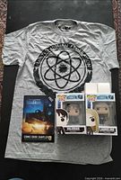 Overview of entire lot: T-shirt, comic sampler, two Funko Pop boxes, two phone fans (boxed)