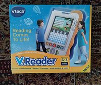 Front of sealed retail box showing V.Reader device and age range 3-7 years