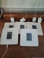 Five Walabot Home devices with four adapters displayed
