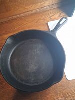 Top view of cast iron skillet showing interior cooking surface and handle.