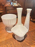 Group of four milk glass pieces: two vases, two bowls