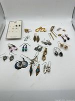 All earrings laid out to show variety and quantity
