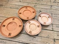Top view showing four round plastic trays, two large and two small