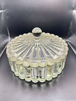 Covered glass bowl showing lid with ribbed columns and knob finial