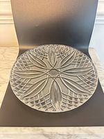 top view of entire clear pressed glass plate showing pattern