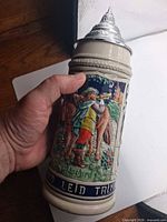 Front view showing figural relief scene and German text