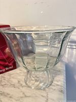 Clear glass footed serving bowl on countertop