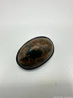 Front view of oval jasper brooch