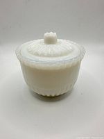 full view of milk glass container with lid on