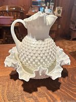 Pitcher on bowl showing overall design