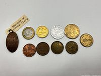 All ten coins and tokens laid out