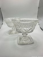 Two pressed glass footed sorbet dishes side by side