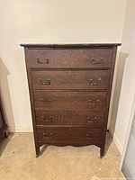 Front view of dresser showing five drawers and handles