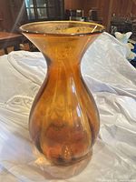 Full view of orange glass vase showing shape and color
