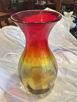 Full side view of tall red yellow vase