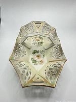 Top view showing full basket shape, reticulated sides, handle, floral motif
