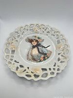 Full view of porcelain plate showing reticulated rim and central portrait