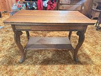 front view showing full table, drawer, legs, bottom shelf