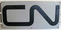 Front view of gray metal sign with black CN logo