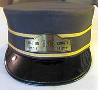 Front view showing badge, braid trim, visor