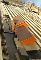 Overhead view showing station, long canopy, figures, shed and surrounding track for scale