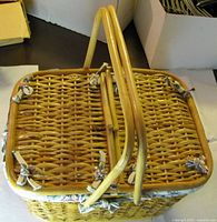 top view of closed wicker picnic basket showing woven pattern and hinges