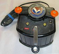 Angled view showing transformer, orange levers, attached cord