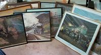 Group of framed train prints leaning together showing variety of frames and subjects