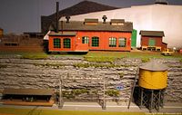 Overall view of engine house, shed, water tank, platform, signal gantry