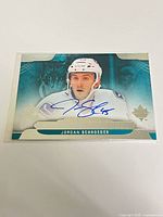 Front view of autographed Jordan Schroeder Ultimate Signatures card in sleeve and top loader