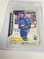 Front view of Elias Pettersson Marquee Rookie card inside Ultra Pro top loader