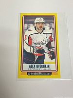 Front view of sleeved Alex Ovechkin yellow border card