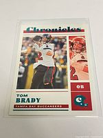 Front view of Tom Brady Panini Chronicles teal parallel card in sleeve