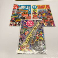 Front covers of all three DC Sampler issues displayed