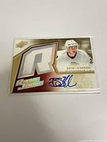 Full view of front of autographed rookie patch card in sleeve