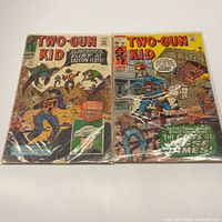 Both bagged Two-Gun Kid comic books side by side
