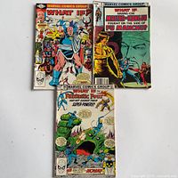 Front covers of all three comics showing titles and artwork