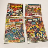 Four bagged Invaders comic books laid out