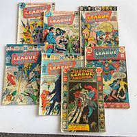 All seven Justice League of America issues arranged flat showing covers