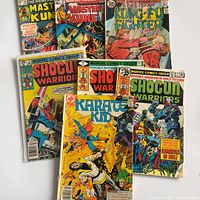 All seven comics fanned out showing covers