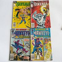 Four comics laid out in 2x2 grid showing full front covers