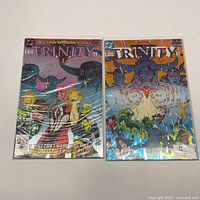 Front view of both Trinity issues in bags