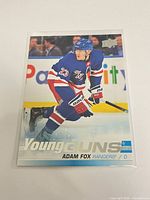 Front view of sleeved Adam Fox Young Guns rookie card